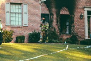 Fire Fighter aiding house fire